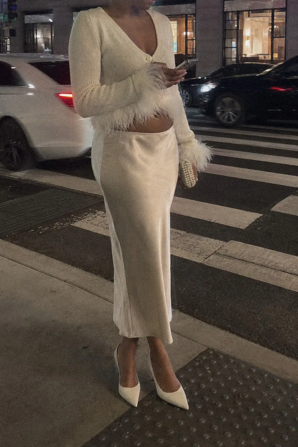 ivory feather trim cropped cardigan champagne satin midi skirt white heels pearl bag white christmas outfit 6