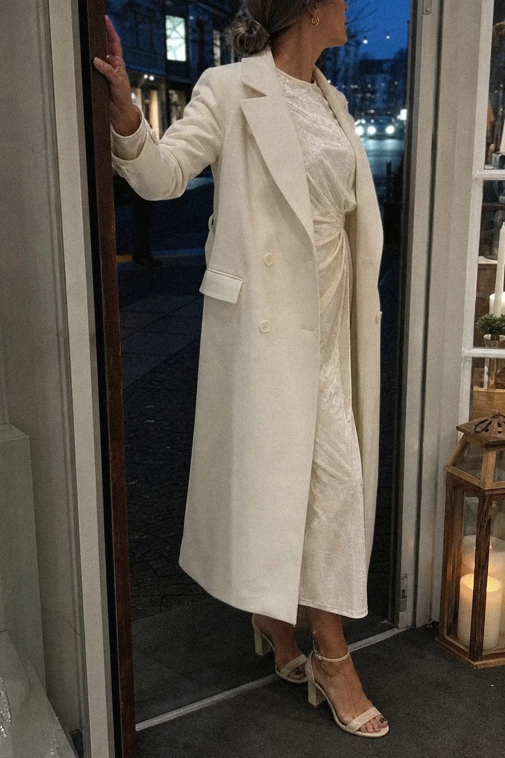 white tailored trench coat cream velvet midi dress ankle strap heels gold earrings white christmas outfit 12