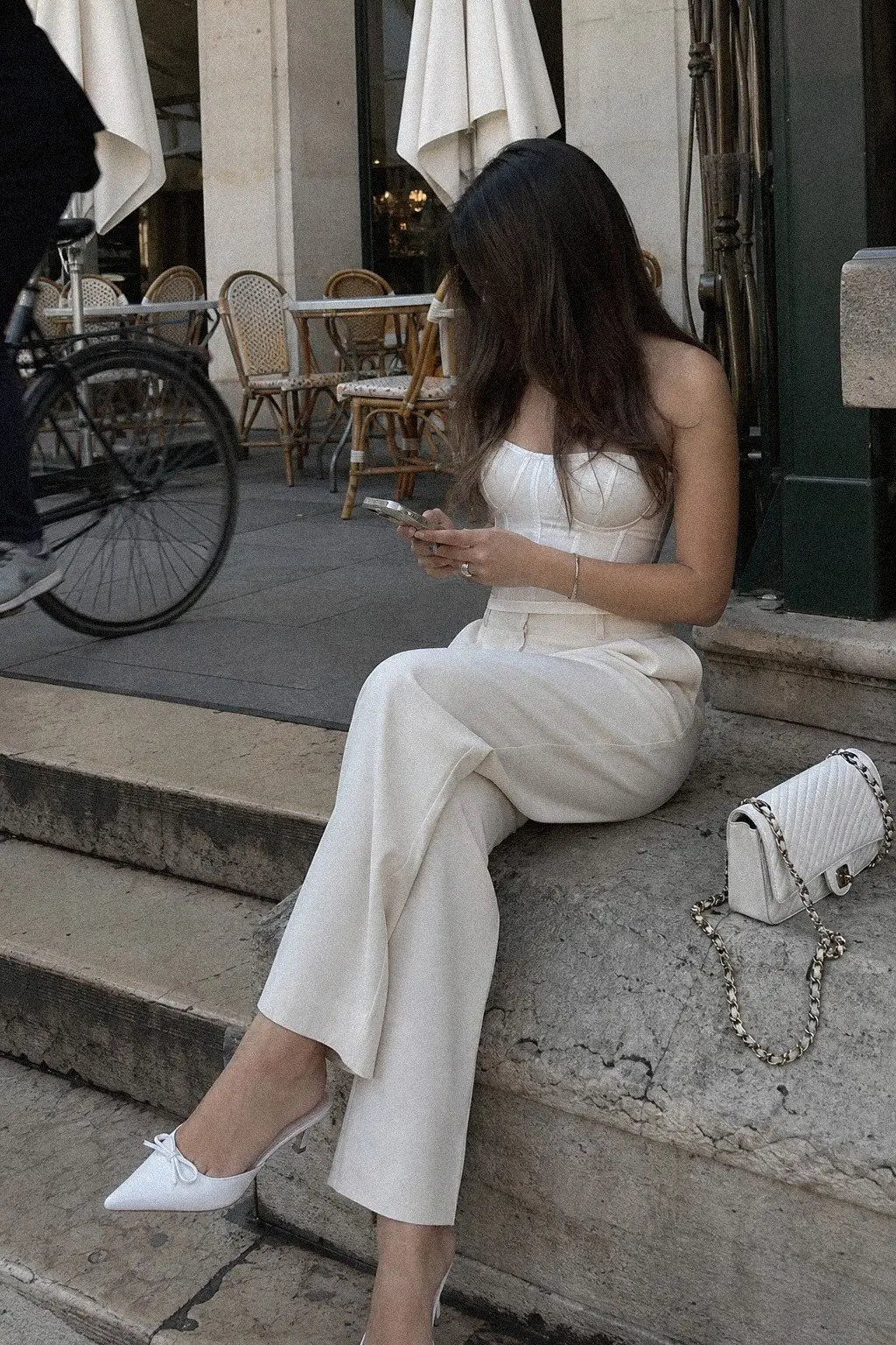 white structured corset top ivory tailored straight leg trousers white mule heels chain bag crystal studs white christmas outfit 17