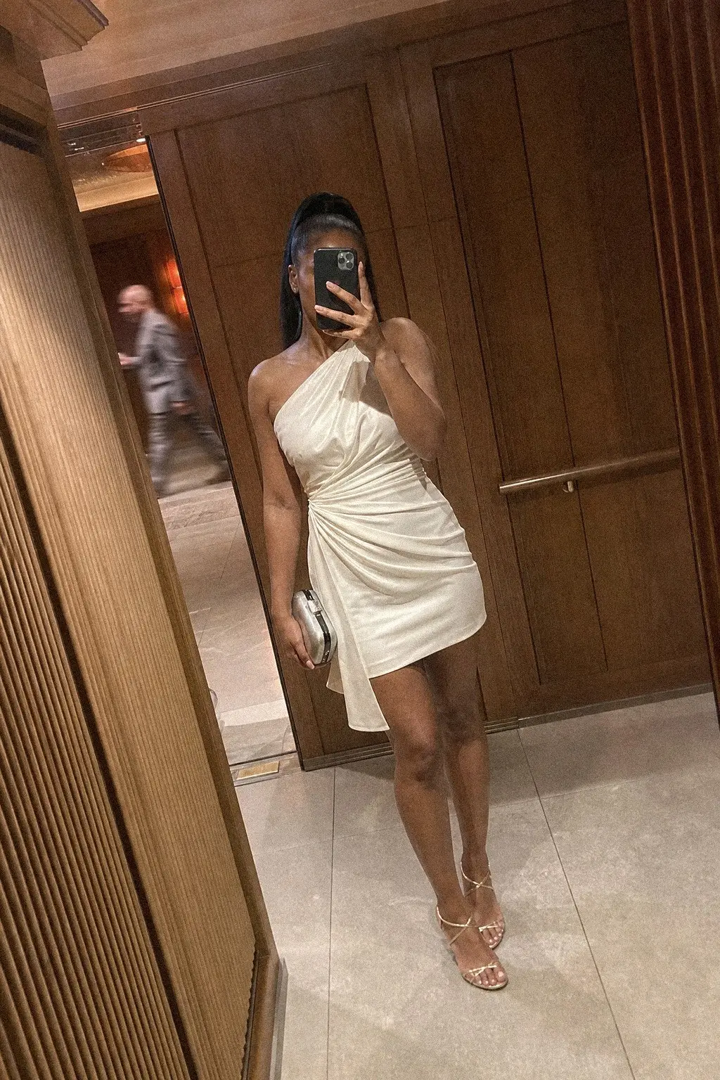 white asymmetric one shoulder draped mini dress champagne strappy heeled sandals silver minaudiere white christmas outfit 22