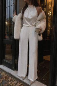 ivory halter neck top white wide leg trousers cream faux fur stole champagne heels pearl bag white christmas outfit 24