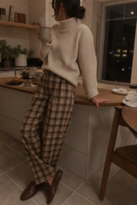 woman in brown cream plaid wide leg trousers cream chunky turtleneck knit brown loafers thanksgiving dinner outfit 11