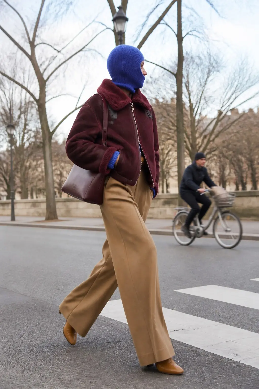 royal blue ribbed knit balaclava burgundy shearling zip jacket camel wide leg trousers tan leather ankle boots structured burgundy leather tote bag outfit 28