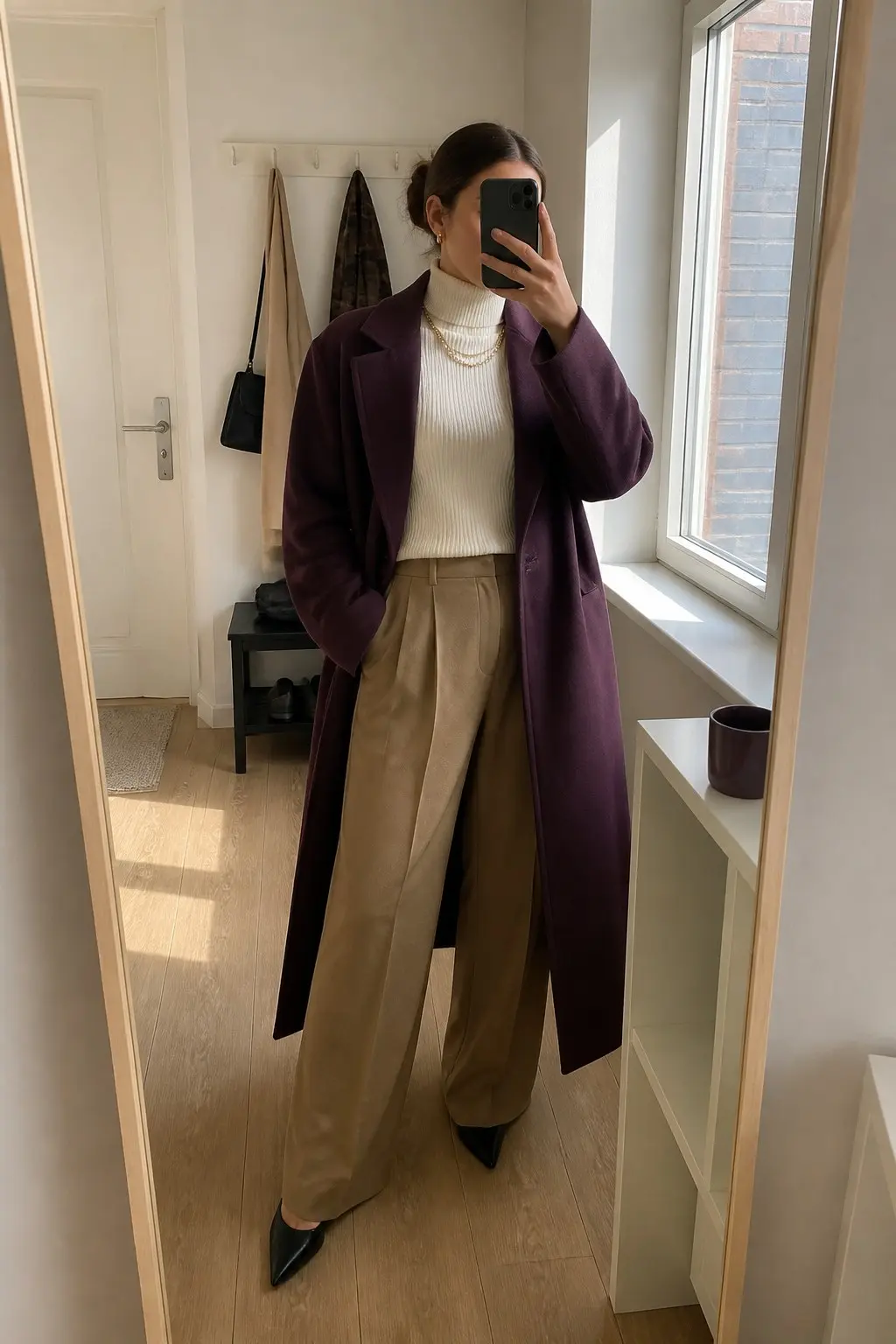 plum wool coat over cream ribbed turtleneck and wide-leg camel trousers with black pointed-toe pumps and gold chain necklace outfit 1