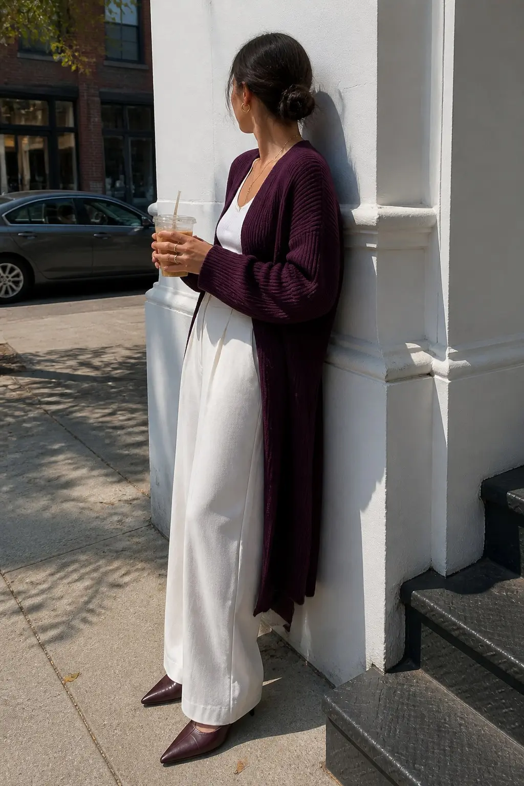 long plum ribbed open cardigan over white cami top white wide leg trousers burgundy leather pointed mules gold stacked rings outfit 16