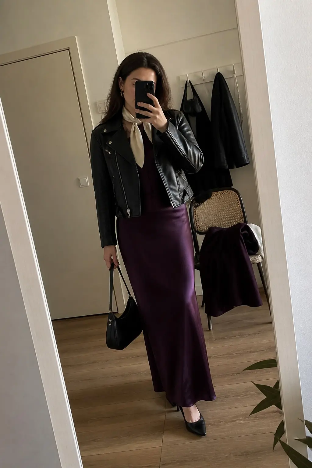 deep purple satin maxi skirt black leather biker jacket cream neck scarf tied loosely black small top-handle shoulder bag black pointed pumps outfit 21