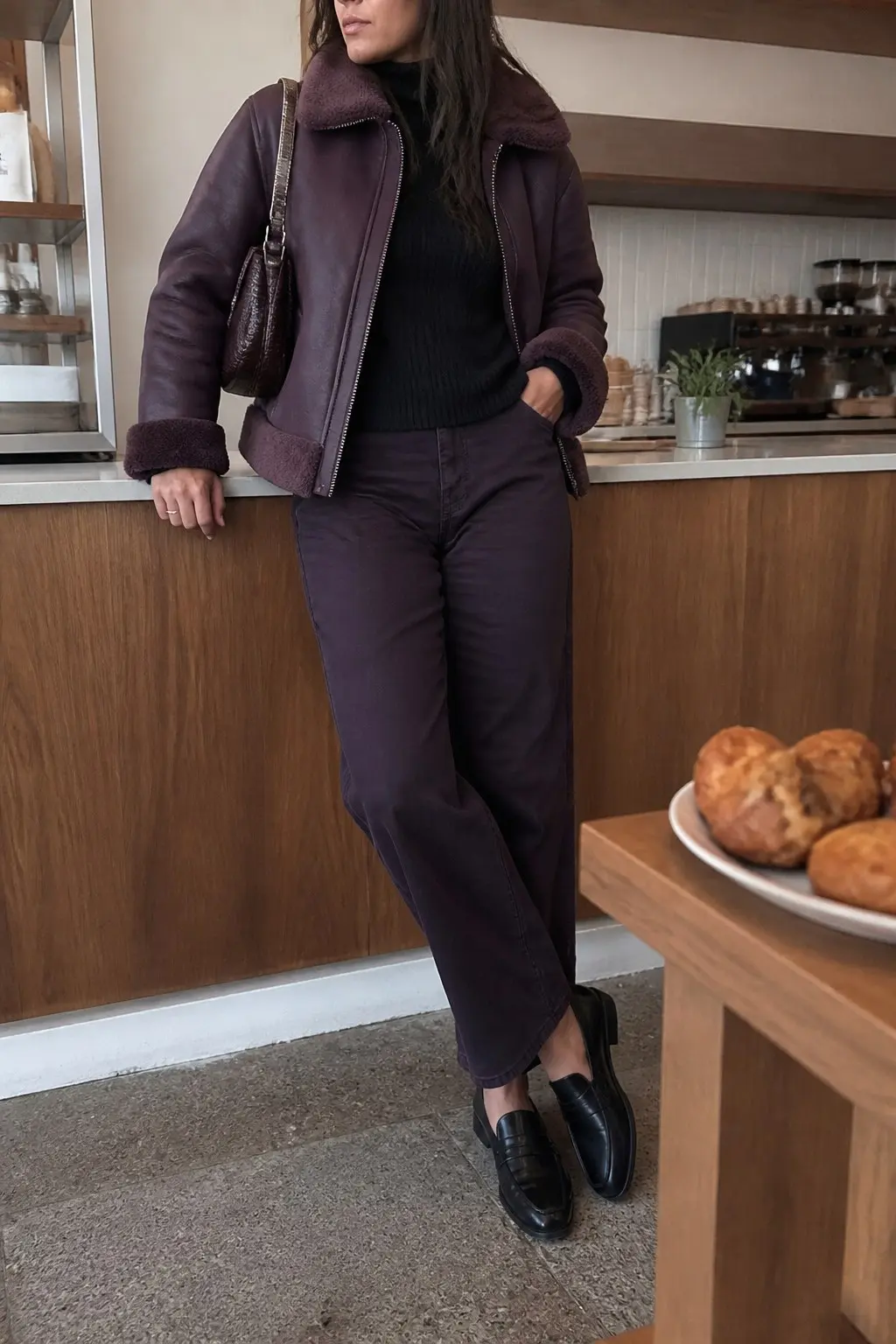 deep purple shearling moto jacket black ribbed turtleneck dark purple straight-leg jeans black leather penny loafers brown croc mini shoulder bag outfit 23