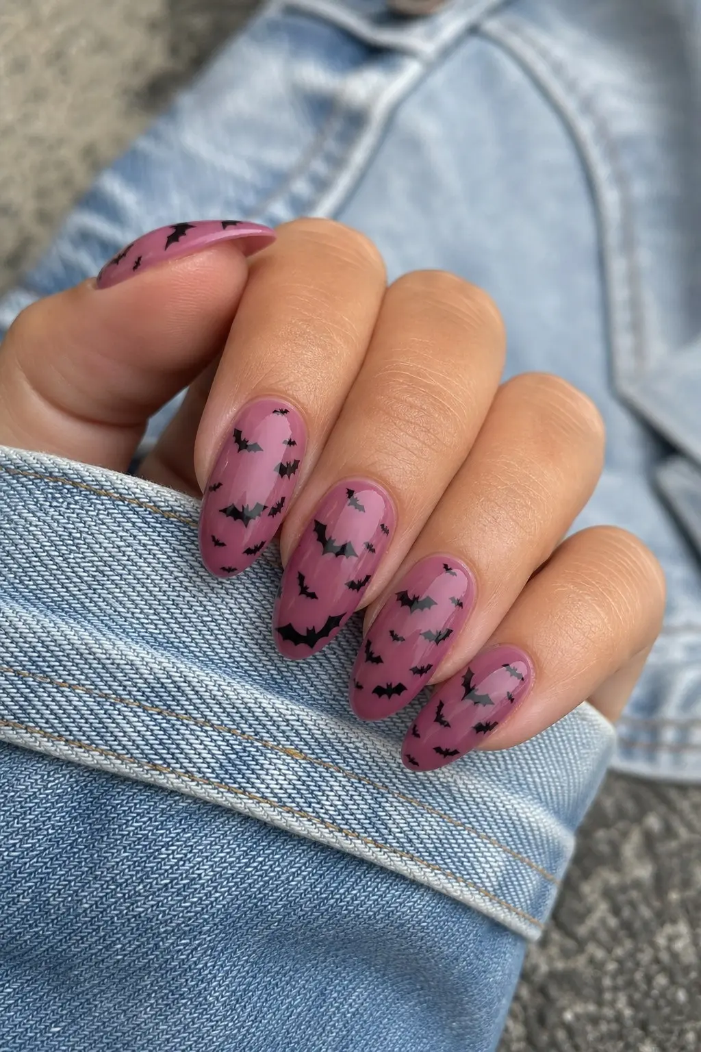 medium almond nails with mauve purple gel base, multiple tiny black bat silhouettes scattered across all nails in flying formation, nail look 12