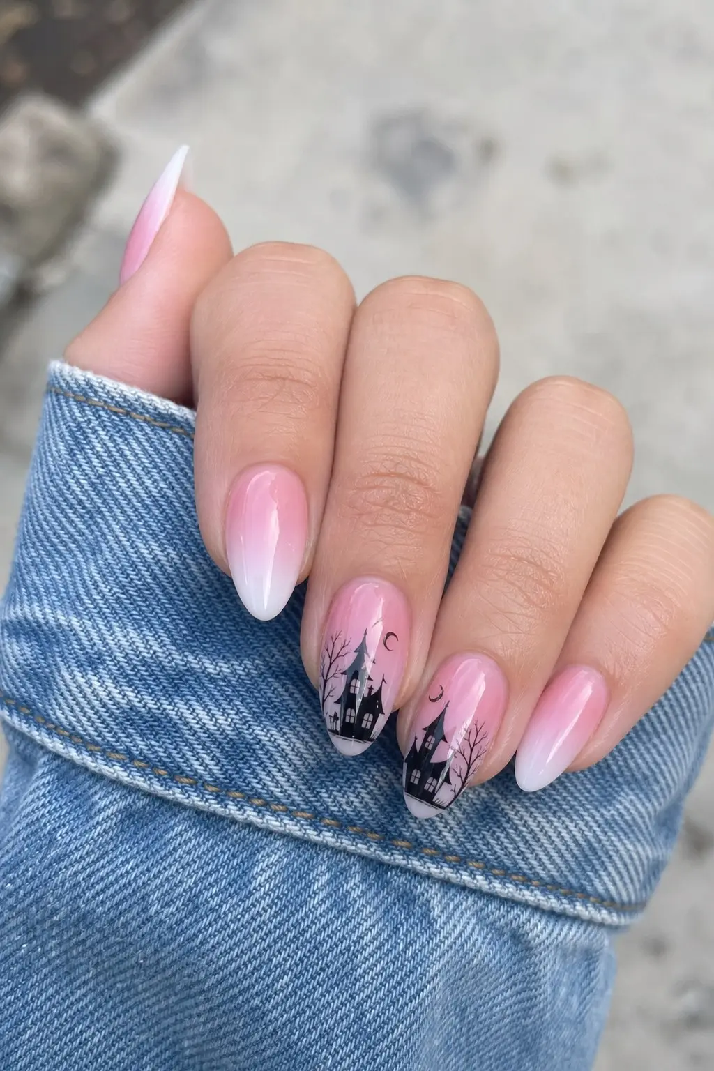 medium almond nails with pink to white ombre gradient base, black haunted house castle bare trees and crescent moon silhouette painted across two accent nails, nail look 22