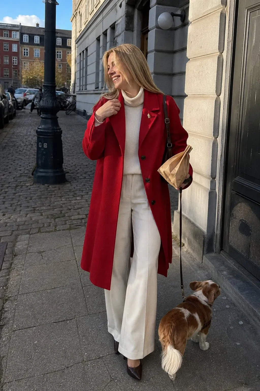 woman in cherry red wool coat cream turtleneck knit cream wide leg trousers dark brown kitten heel pumps brown leather crossbody bag gold lapel pin outfit 19