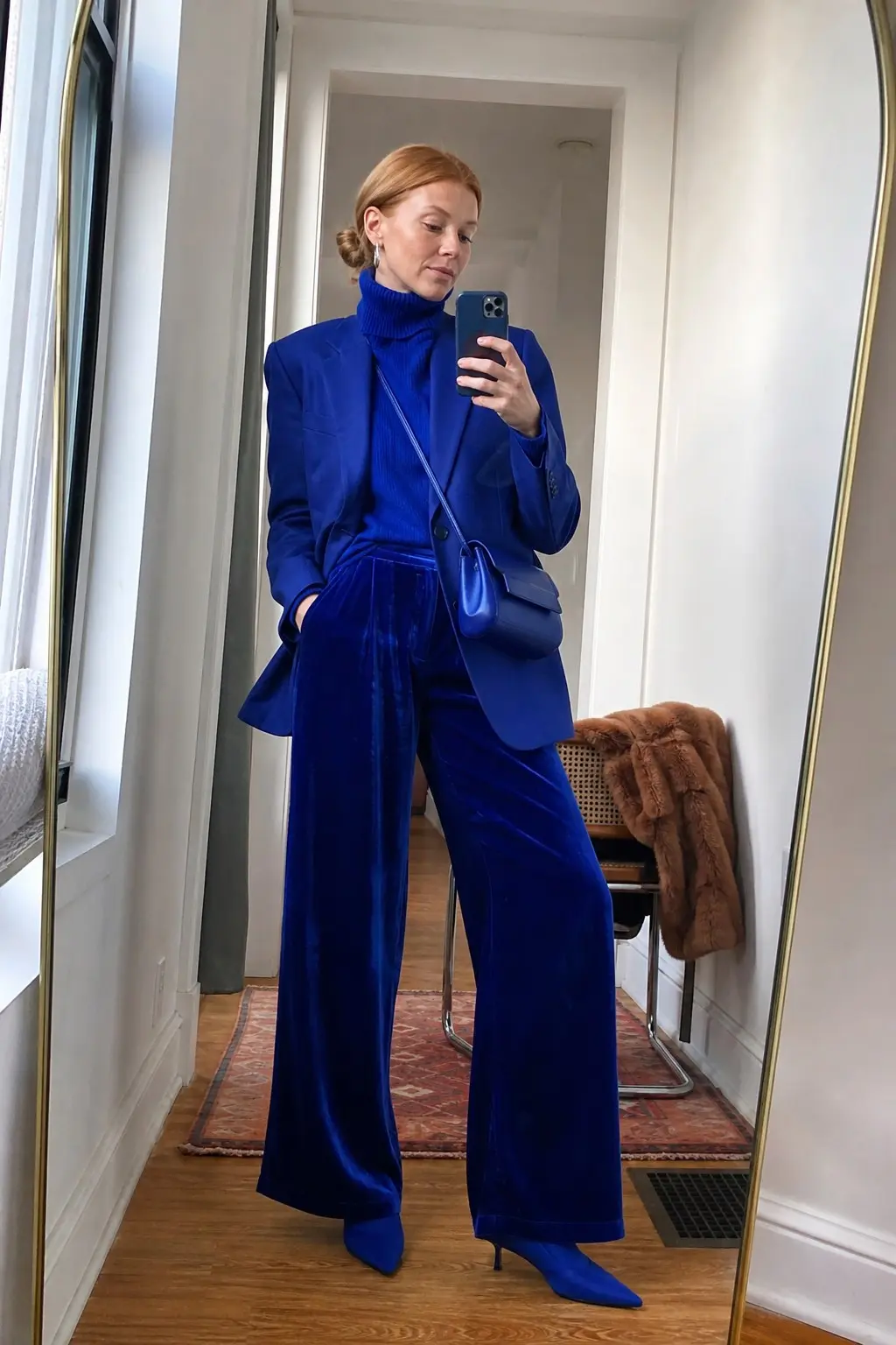 woman in cobalt blue velvet wide-leg trousers cobalt blue structured blazer cobalt ribbed turtleneck cobalt kitten heel pointed boots cobalt blue crossbody bag small silver hoop earrings outfit 5
