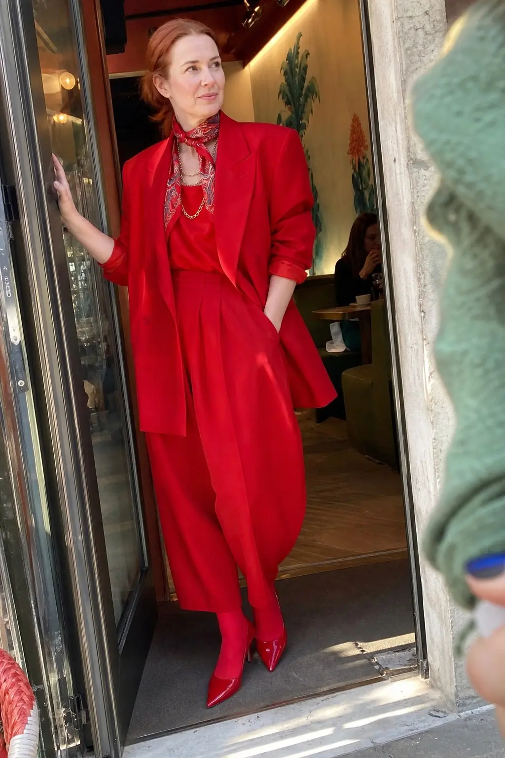 woman in red oversized blazer matching red wide leg trousers red opaque tights red patent pointed pumps red printed silk neck scarf layered gold chain necklace outfit 13