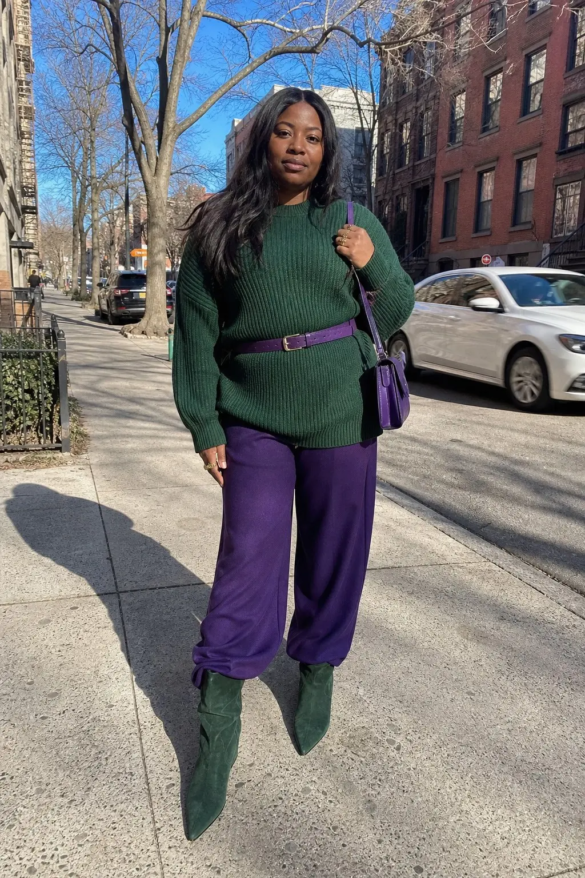 woman in forest green oversized chunky ribbed knit sweater purple leather belt royal purple wide leg trousers green suede slouch ankle boots small purple crossbody bag gold hoop rings outfit 14