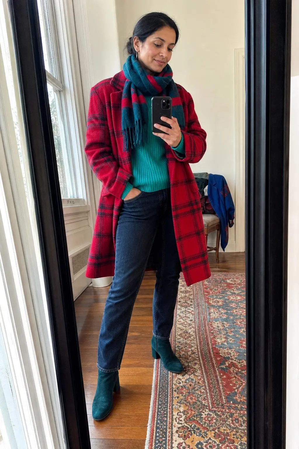 woman in red plaid oversized coat bright teal ribbed knit sweater dark denim straight jeans teal suede ankle boots teal and red striped fringe scarf outfit 17