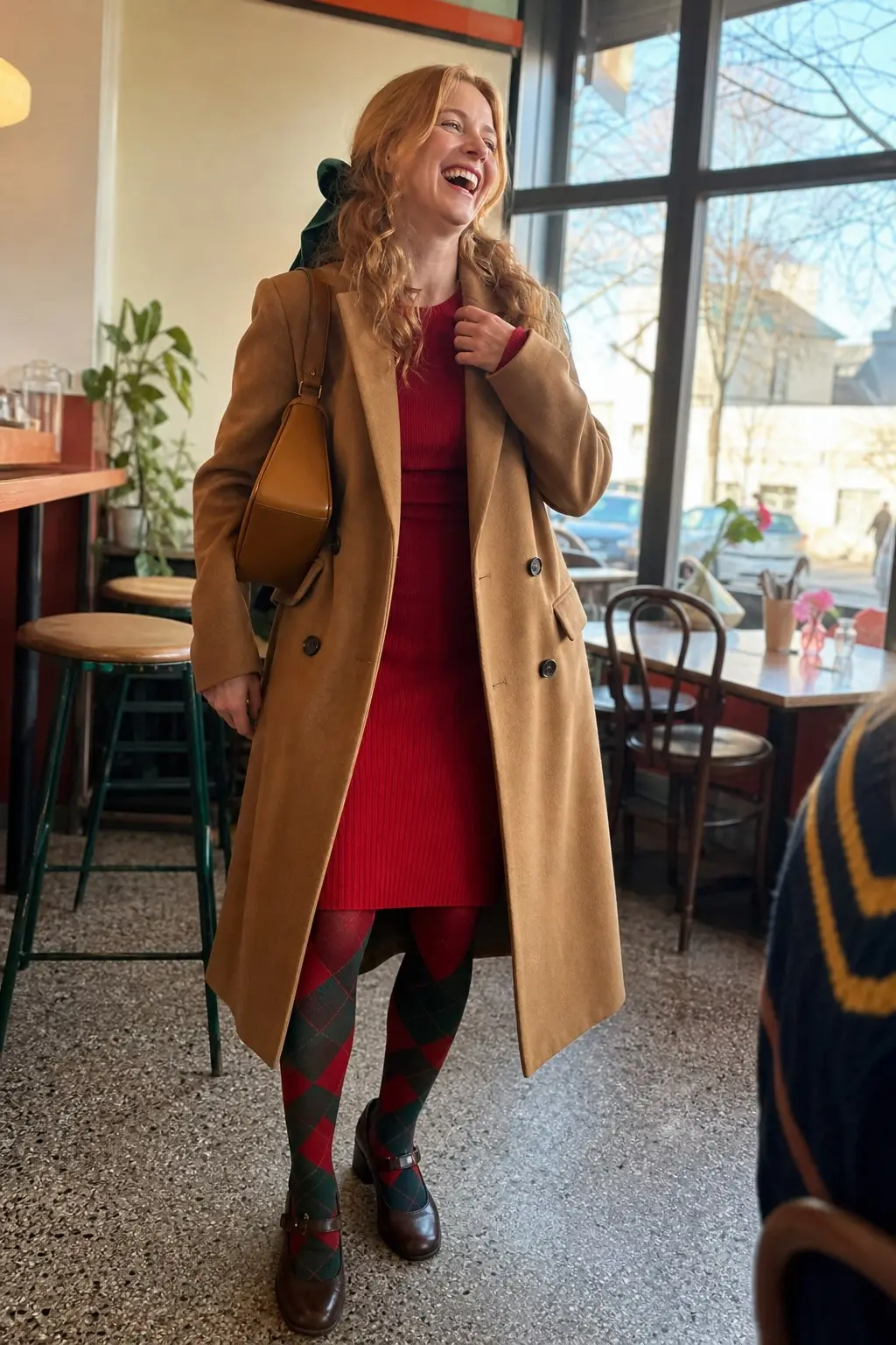 woman in camel double breasted wool midi coat red ribbed knit mini dress red green argyle tights dark brown mary jane block heel shoes tan structured shoulder bag outfit 19
