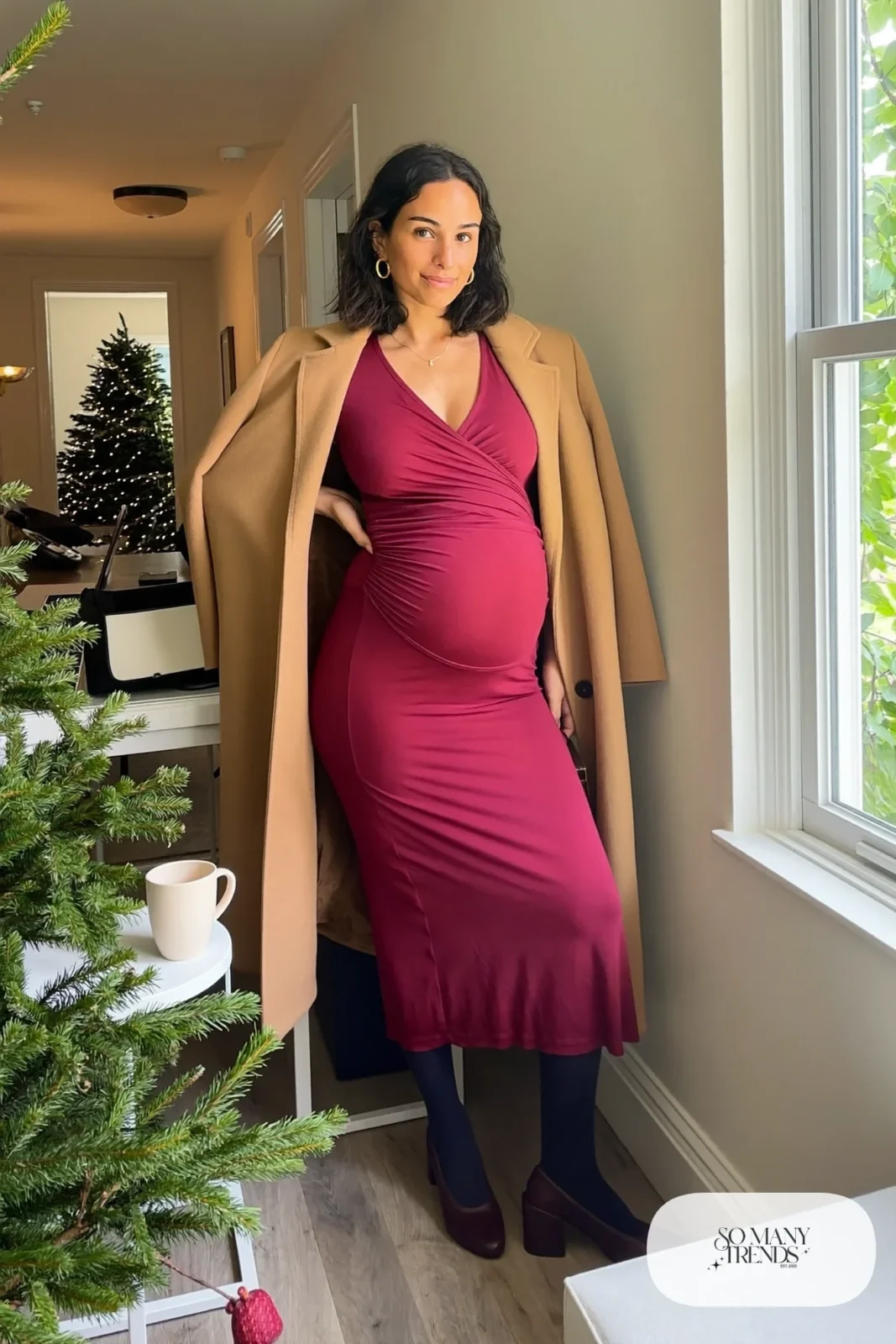 pregnant woman in burgundy wrap midi dress, open camel wool coat, dark tights, block heel pumps, gold hoop earrings, outfit 1