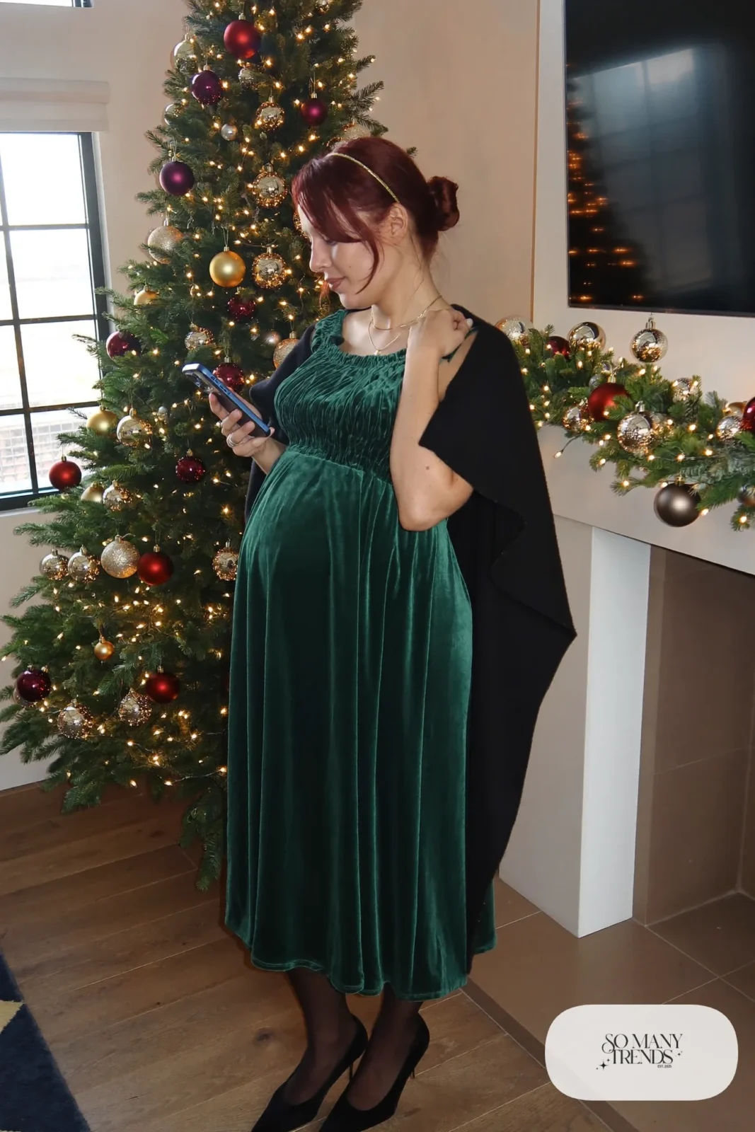 pregnant woman in forest green velvet smocked bodice midi dress, black wool shawl, sheer tights, black closed toe pumps, gold headband, outfit 8