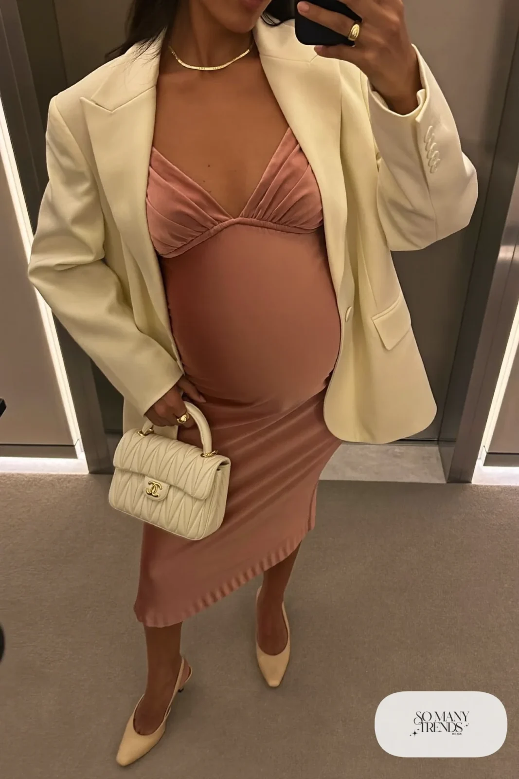 pregnant woman in dusty rose satin midi dress, ivory tailored blazer, nude slingback heels, gold chain necklace, ivory quilted bag, outfit 9