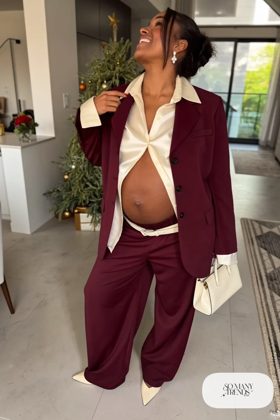 pregnant woman in burgundy wide leg trousers, ivory silk blouse, matching burgundy blazer, cream belt above bump, cream pointed toe flats, ivory top handle bag, pearl earrings, outfit 19