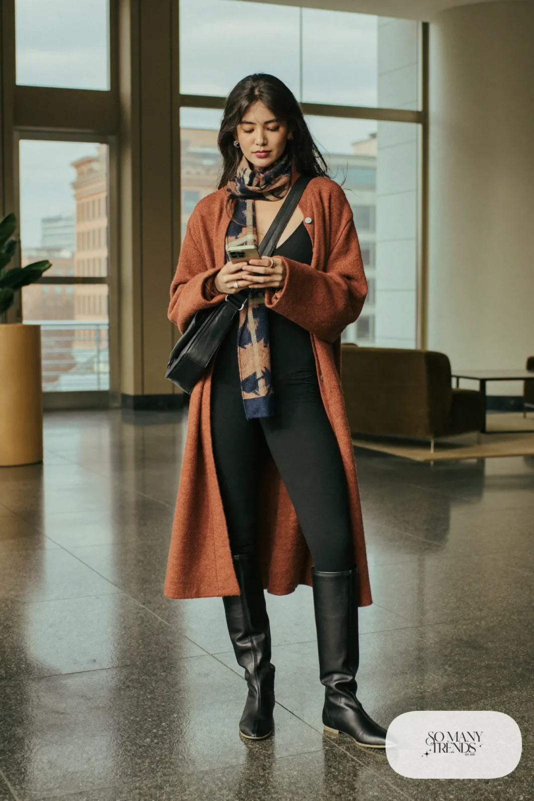camel long cardigan coat black bodysuit black slim trousers tall black boots patterned scarf outfit 8