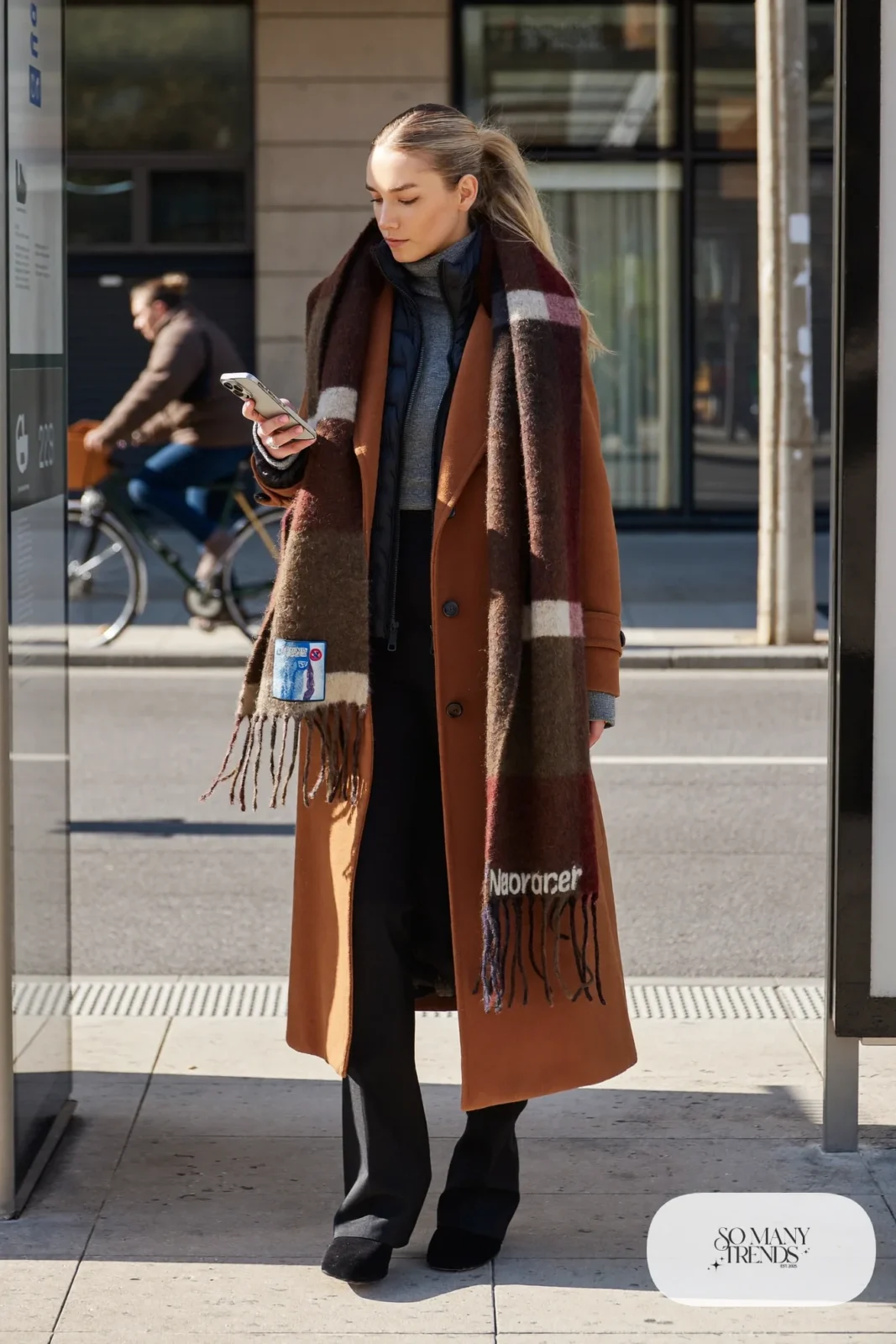 thin black puffer jacket long camel coat grey knit slim black trousers black boots scarf outfit 32