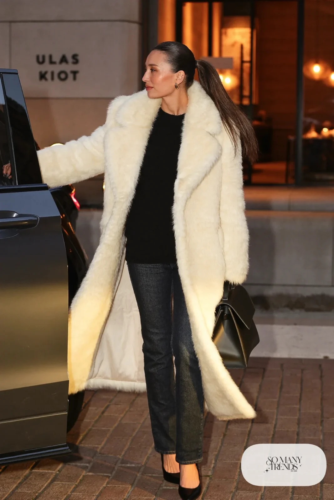 cream faux fur coat dark jeans black sweater black pumps top handle bag outfit 23