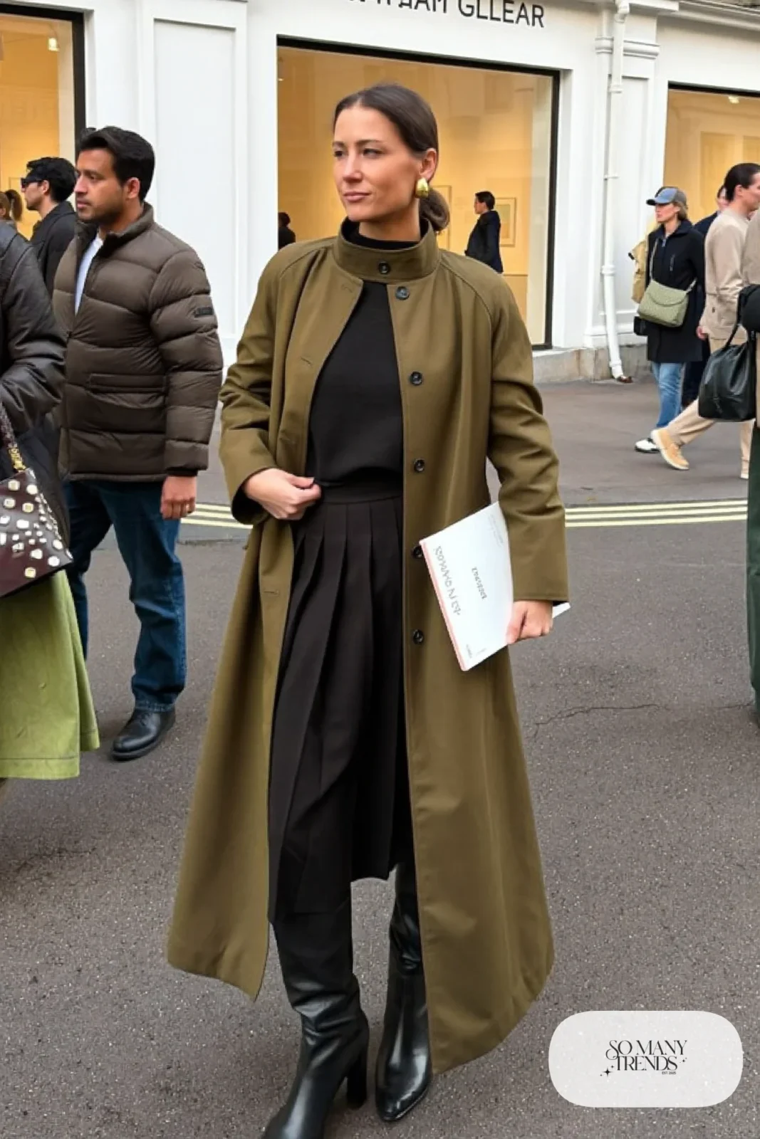 olive funnel neck long coat black fine knit pleated midi skirt tall black boots outfit 11