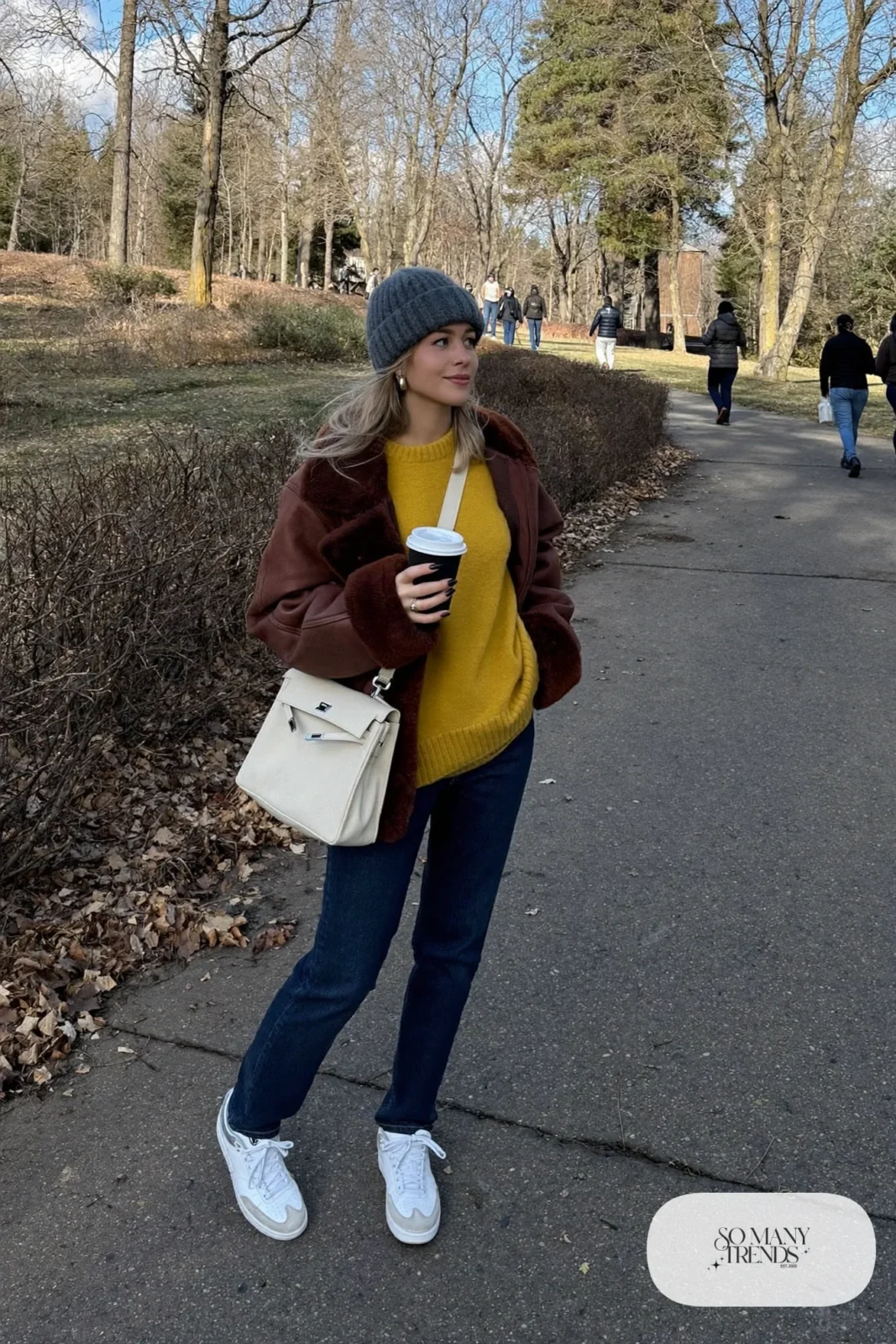 faux shearling jacket mustard sweater dark jeans white sneakers knit hat outfit 14