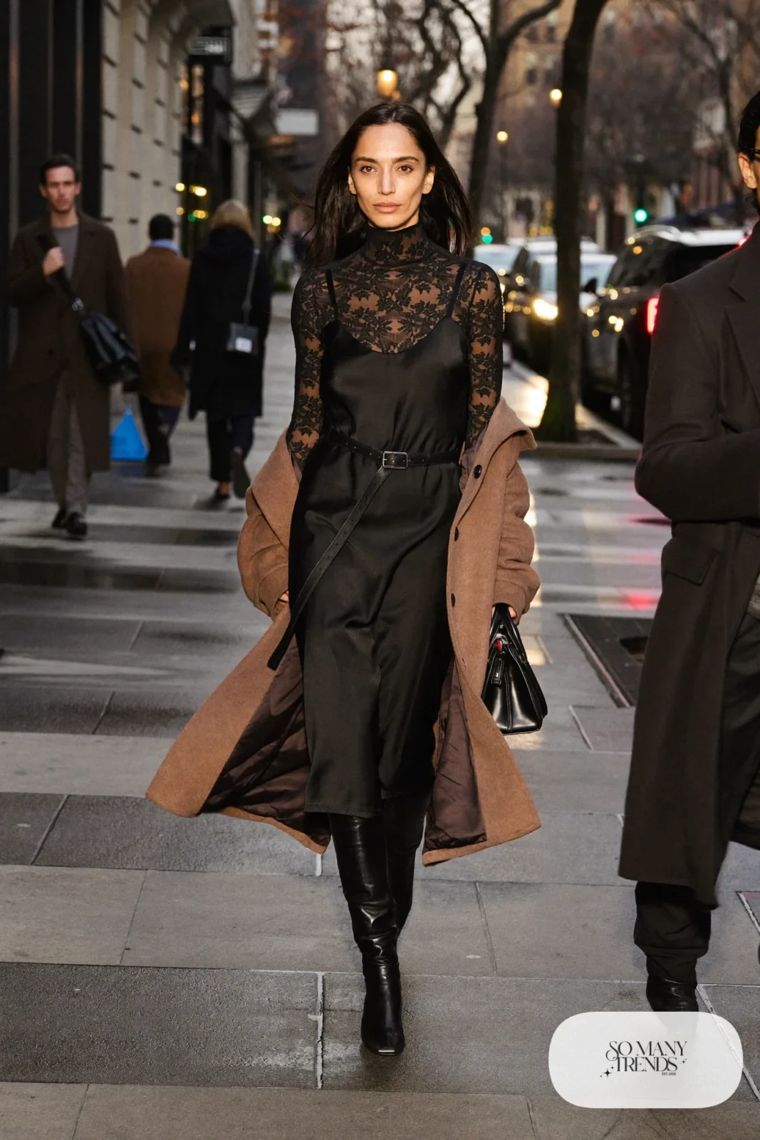 lace top layered over black slip dress belted camel coat tall black boots outfit 20