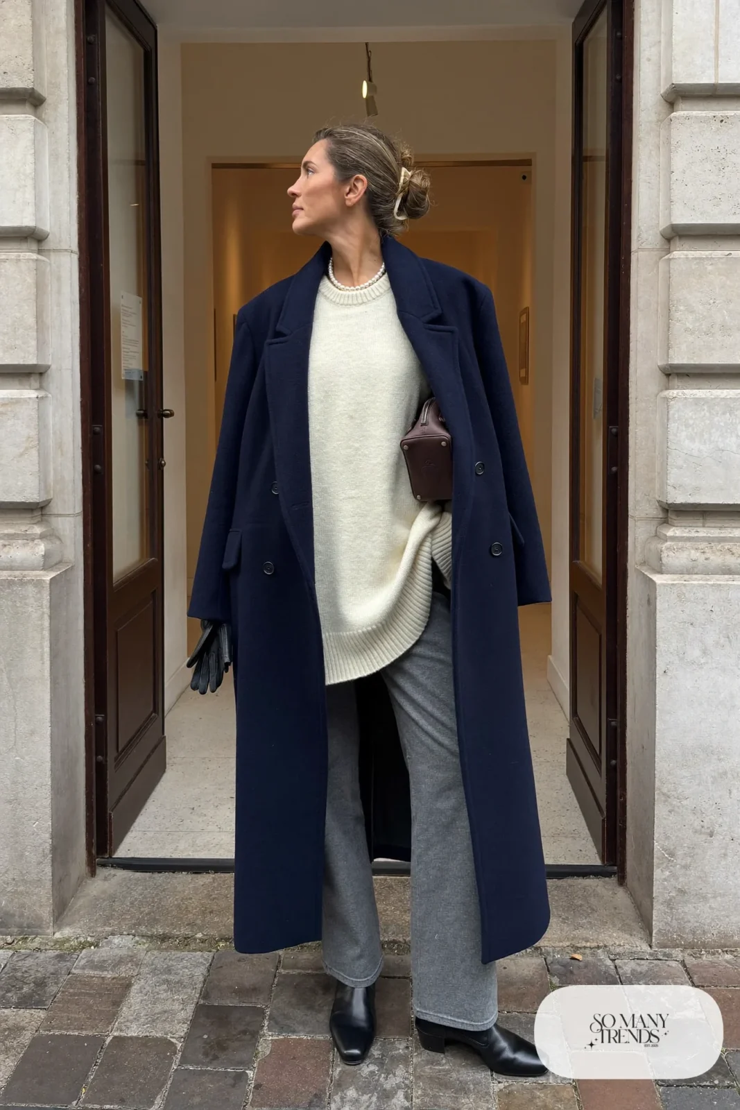 long navy wool overcoat, ivory ribbed sweater, pearl necklace, gray straight pants, black ankle boots, outfit 2
