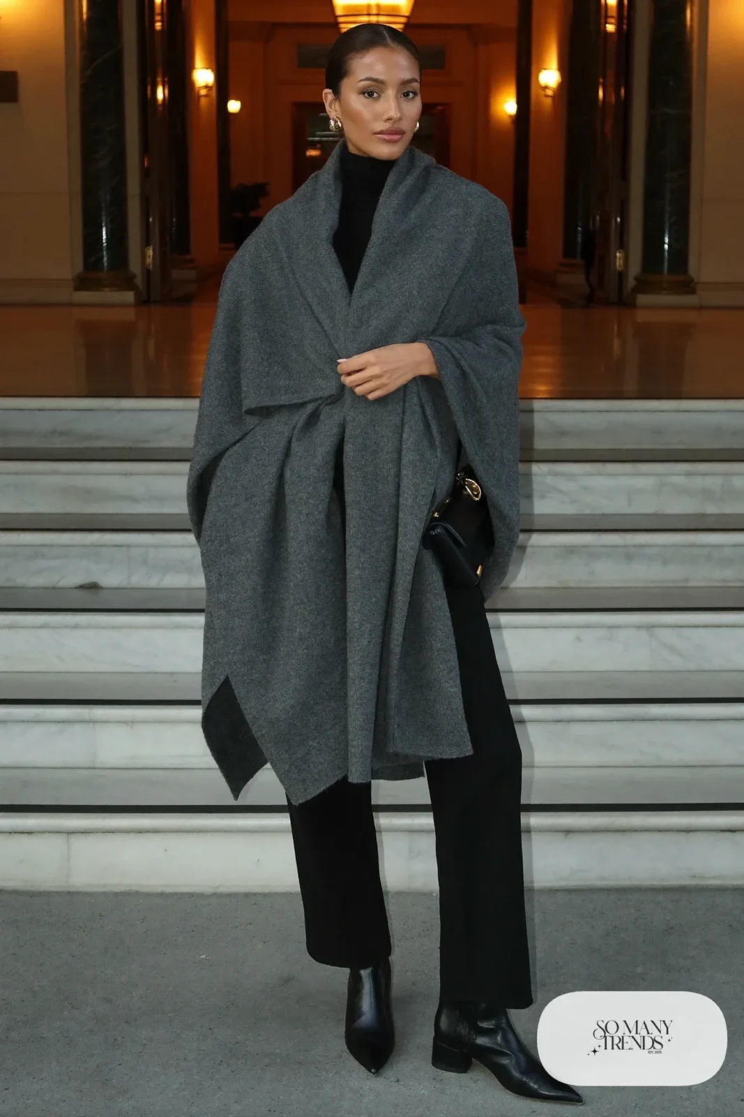 large gray cashmere wrap, black turtleneck, straight black pants, black ankle boots, gold hoops, outfit 25