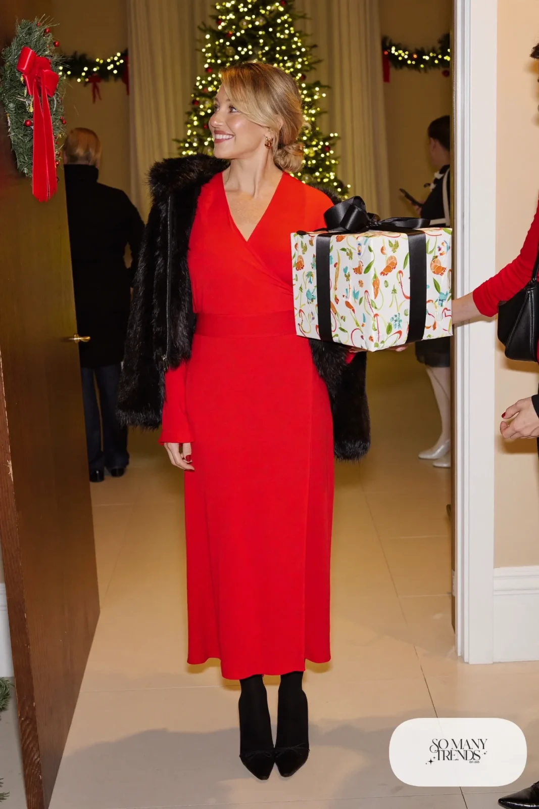 red wrap midi dress black opaque tights black closed toe heels black faux fur jacket holiday outfit 21
