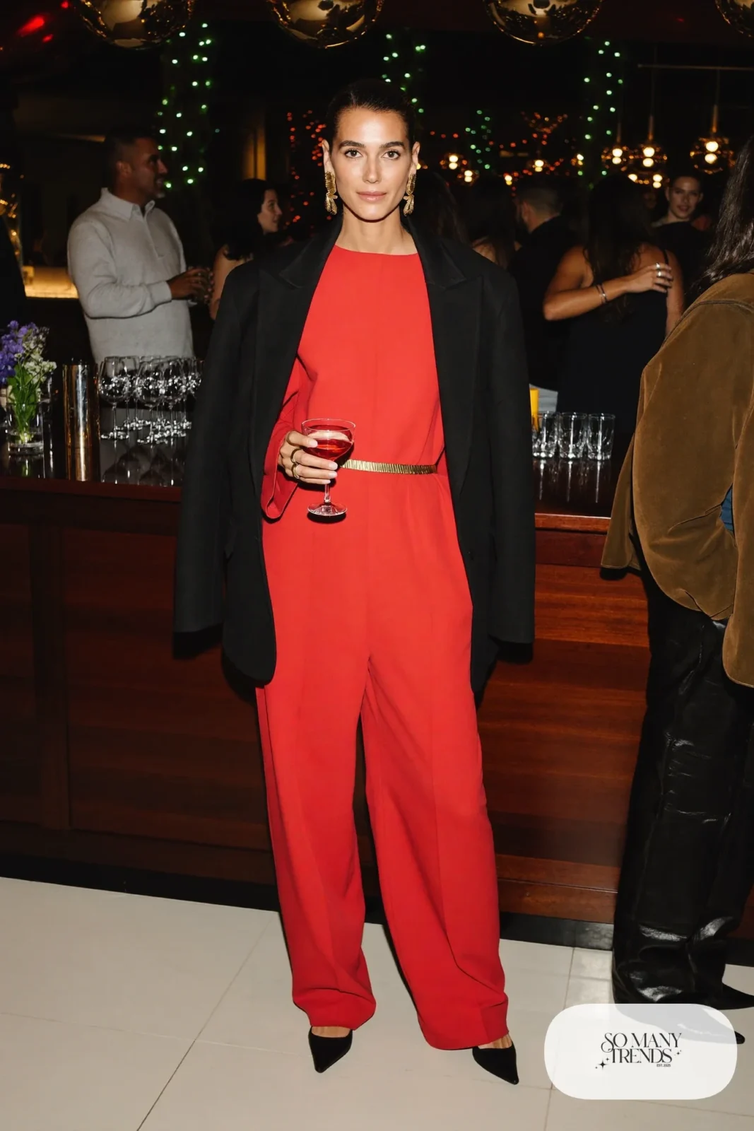 red wide leg jumpsuit gold belt black blazer black pointed pumps holiday outfit 22