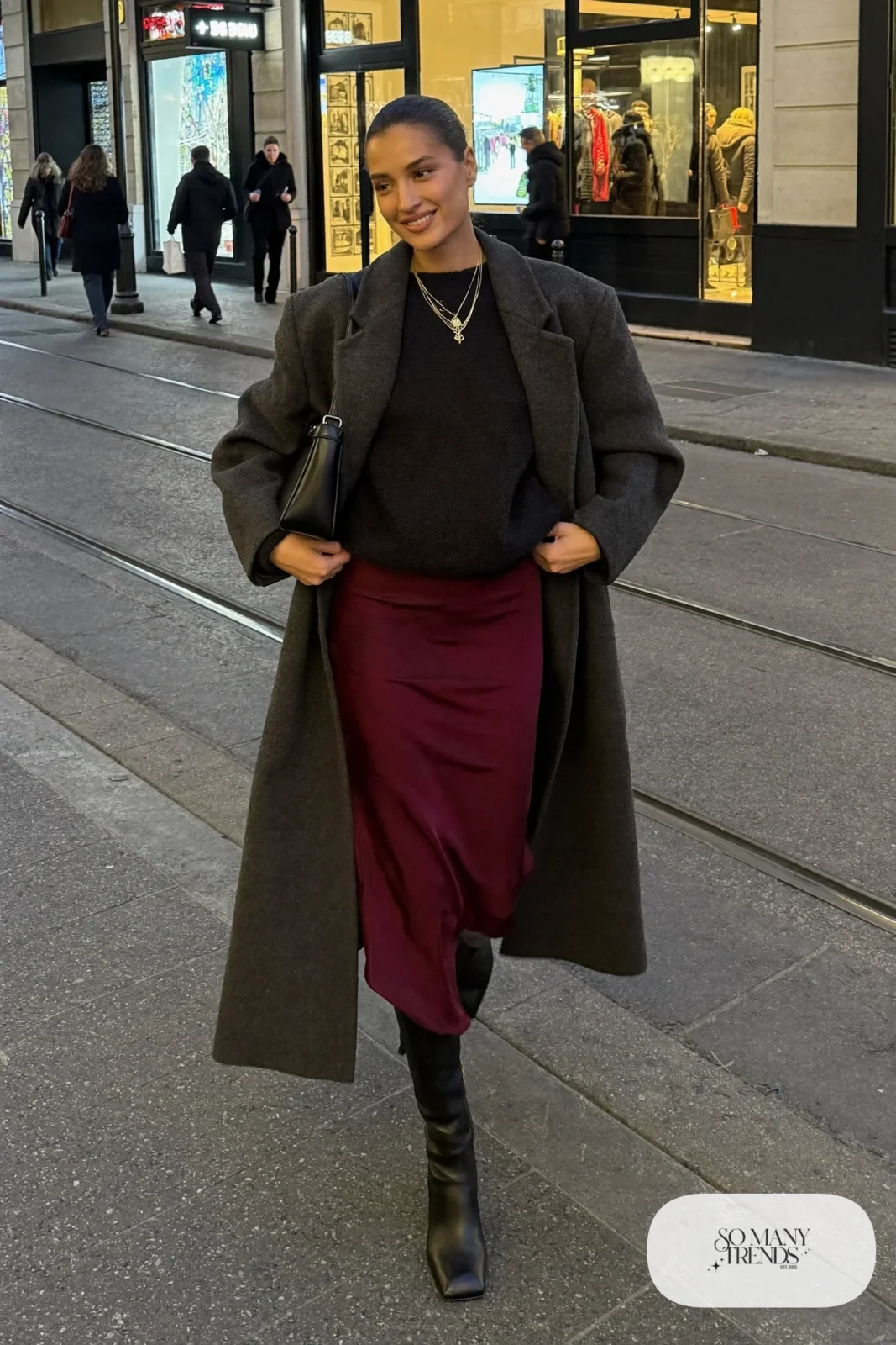 burgundy satin midi skirt chunky black sweater black knee-high boots long coat small shoulder bag outfit 16