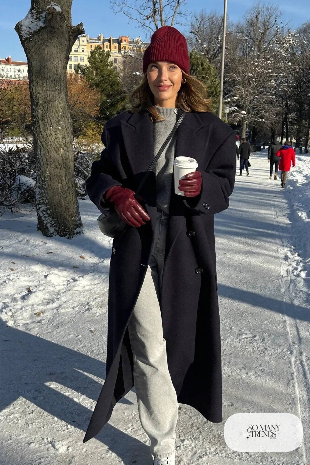 burgundy ribbed wool beanie burgundy gloves long navy coat gray jeans white sneakers crossbody bag outfit 28