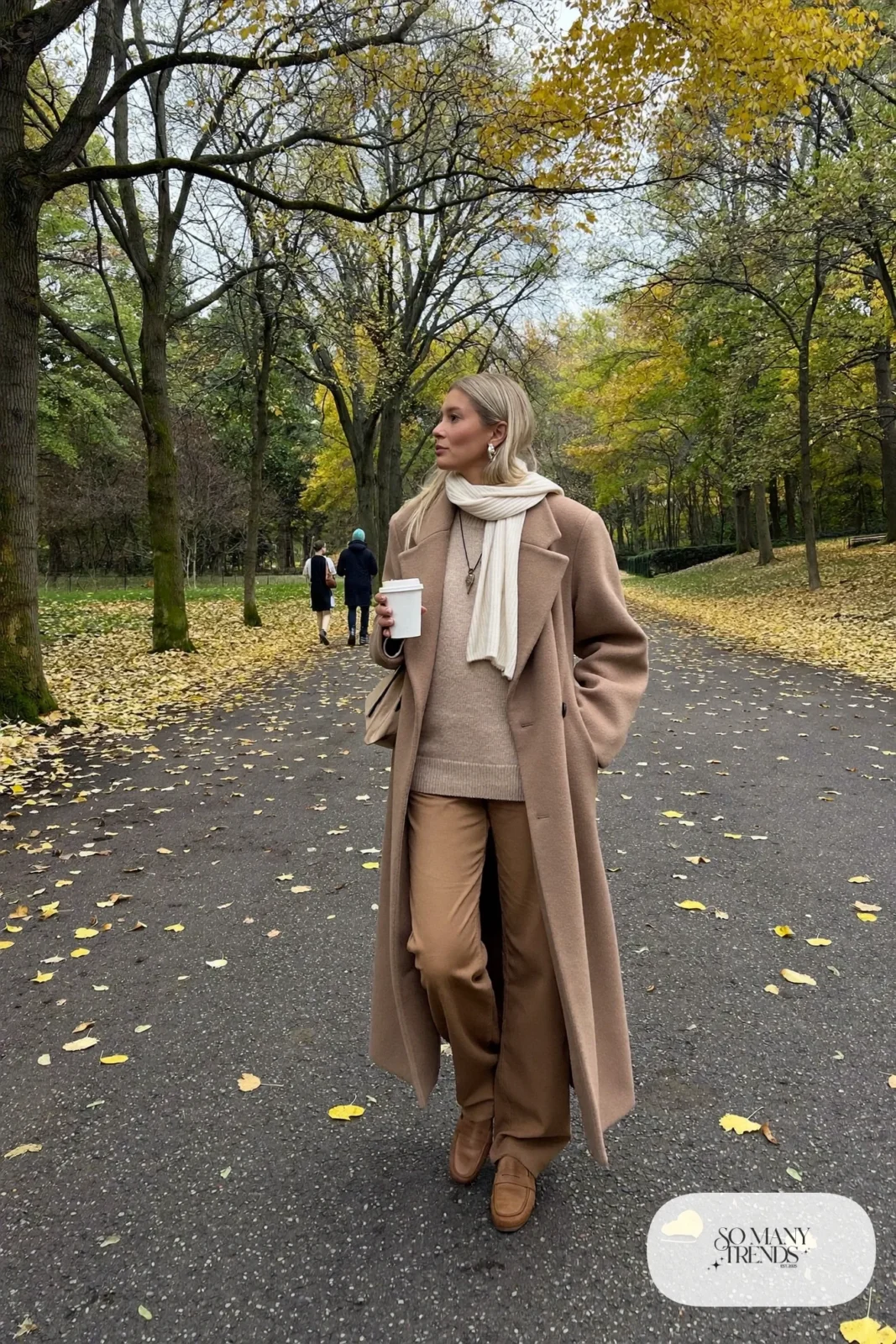 woman in camel long coat, knit sweater, straight pants and loafers outfit 10
