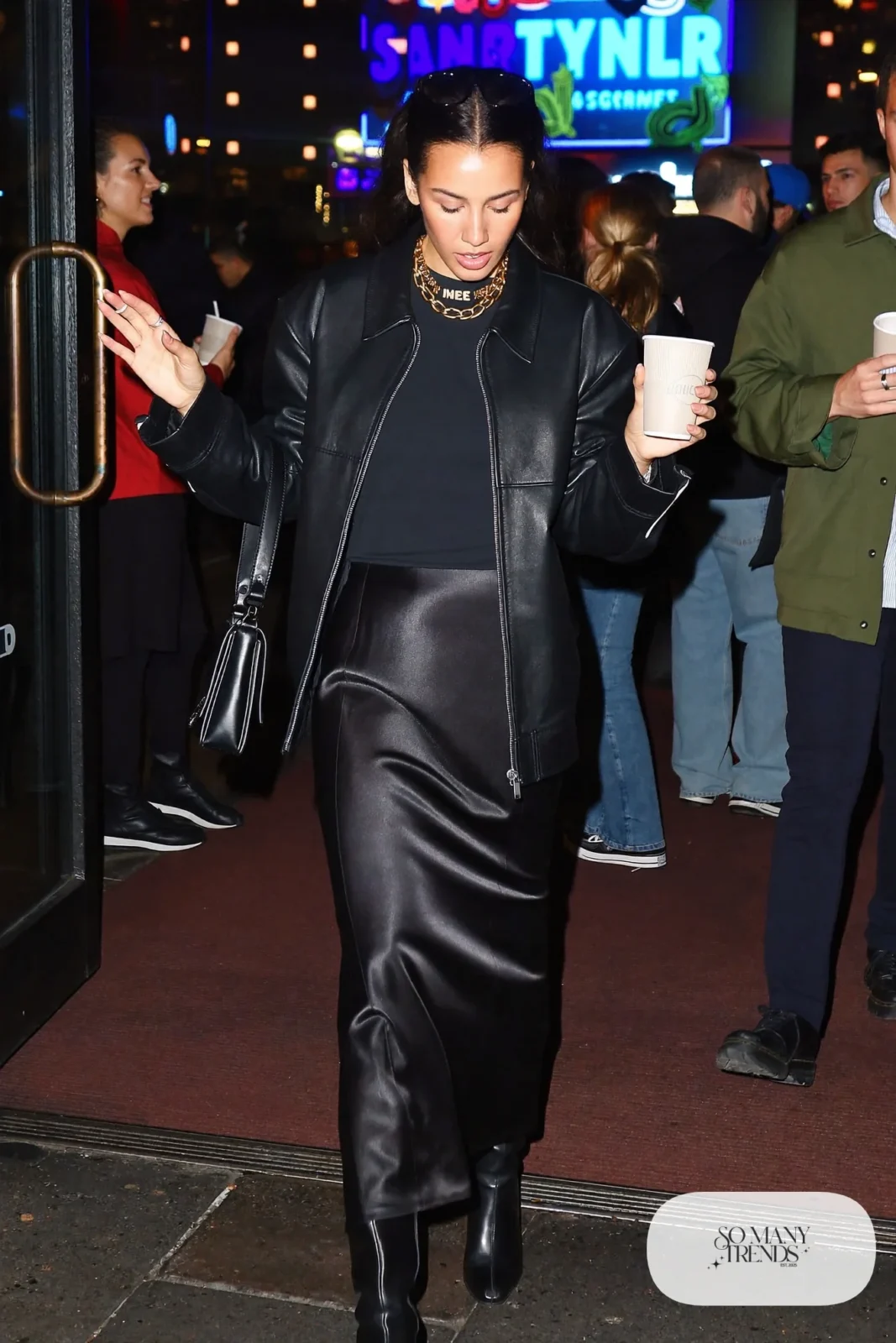 woman in black boxy leather jacket, long skirt, tee and tall boots outfit 11