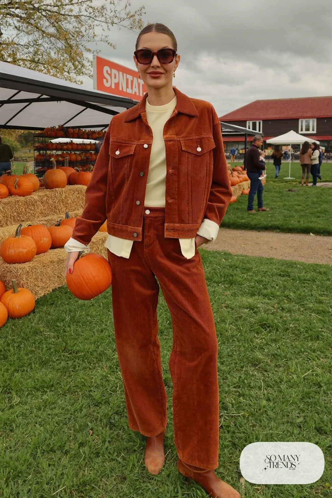 woman in rust corduroy jacket, straight pants, cream tee and boots outfit 17