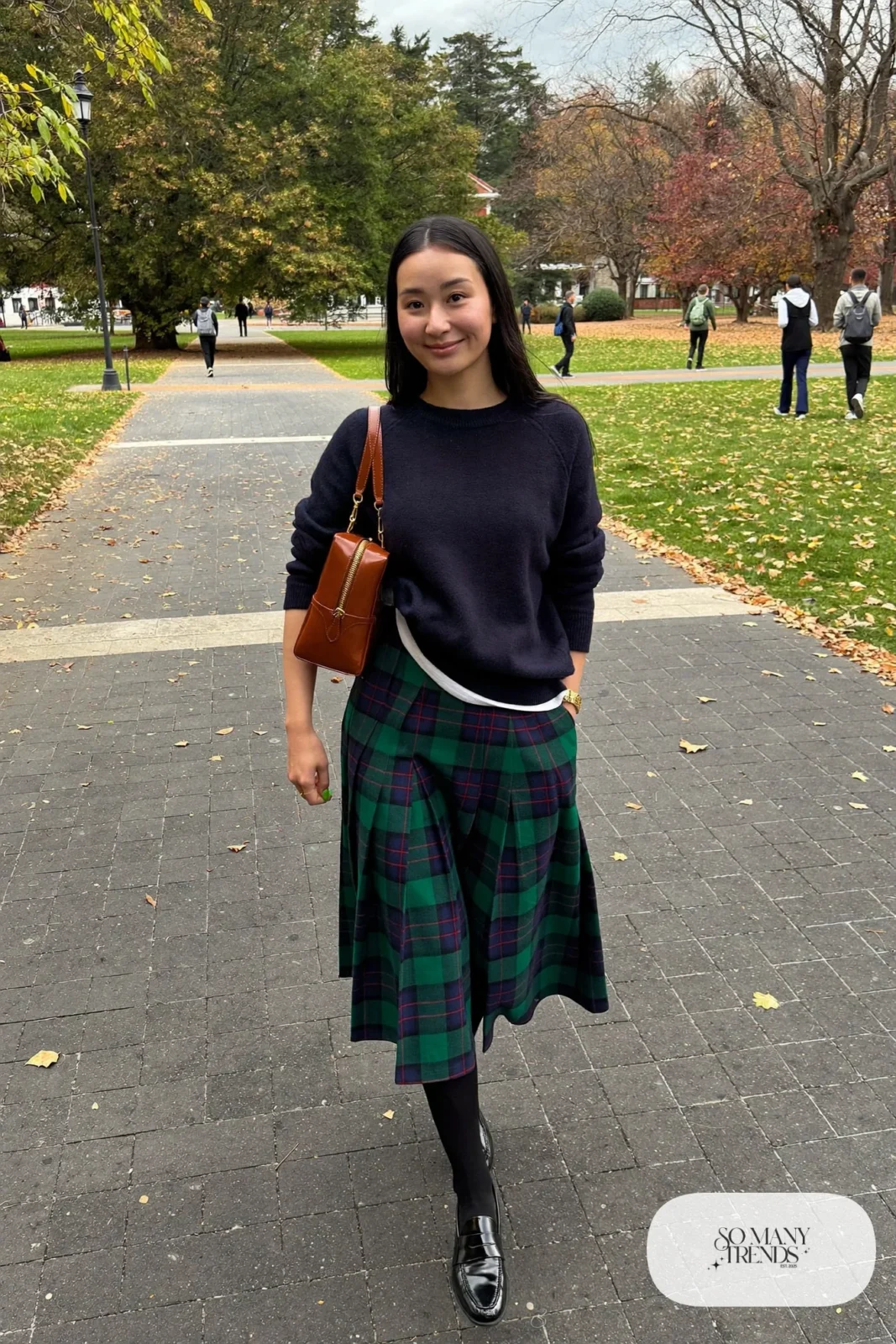 navy sweater, green and navy pleated plaid midi skirt, black tights, black loafers, leather bag outfit 7