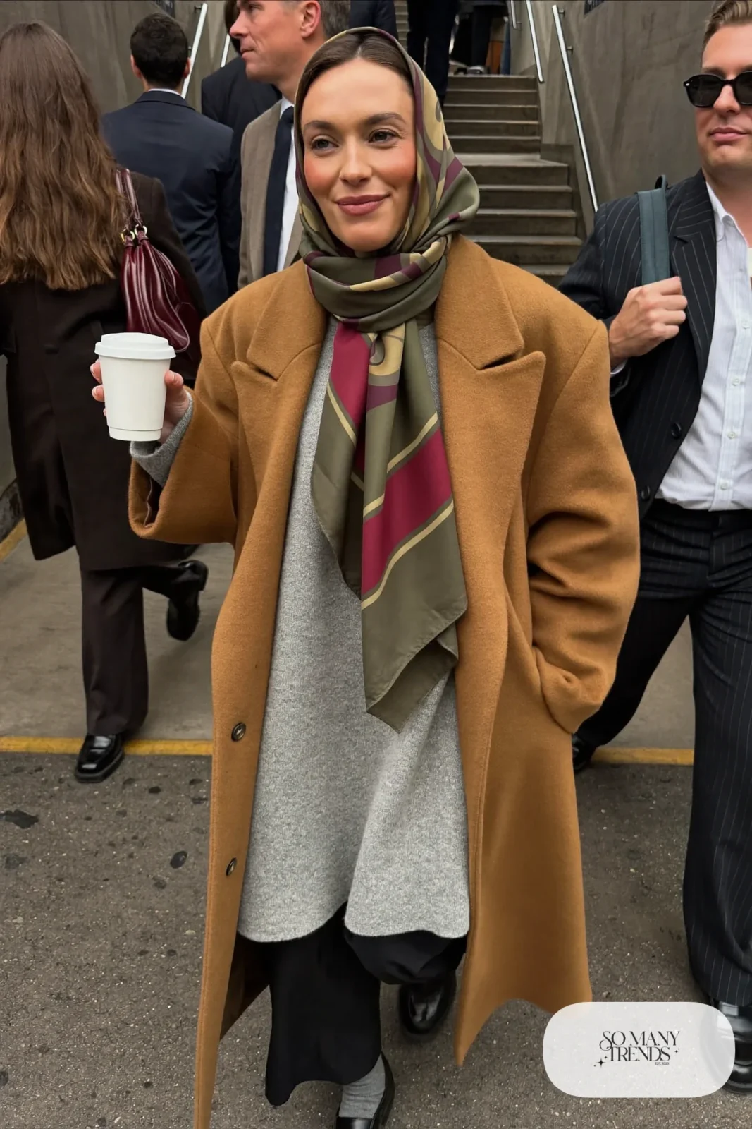 camel oversized long wool coat gray knit sweater black straight pants black loafers silk scarf outfit 1