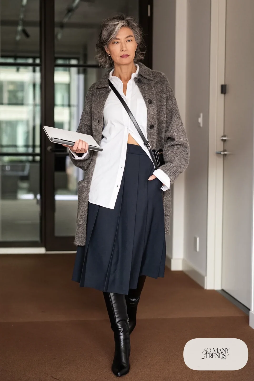 navy pleated midi skirt gray long cardigan white blouse black knee-high boots crossbody bag office outfit 3