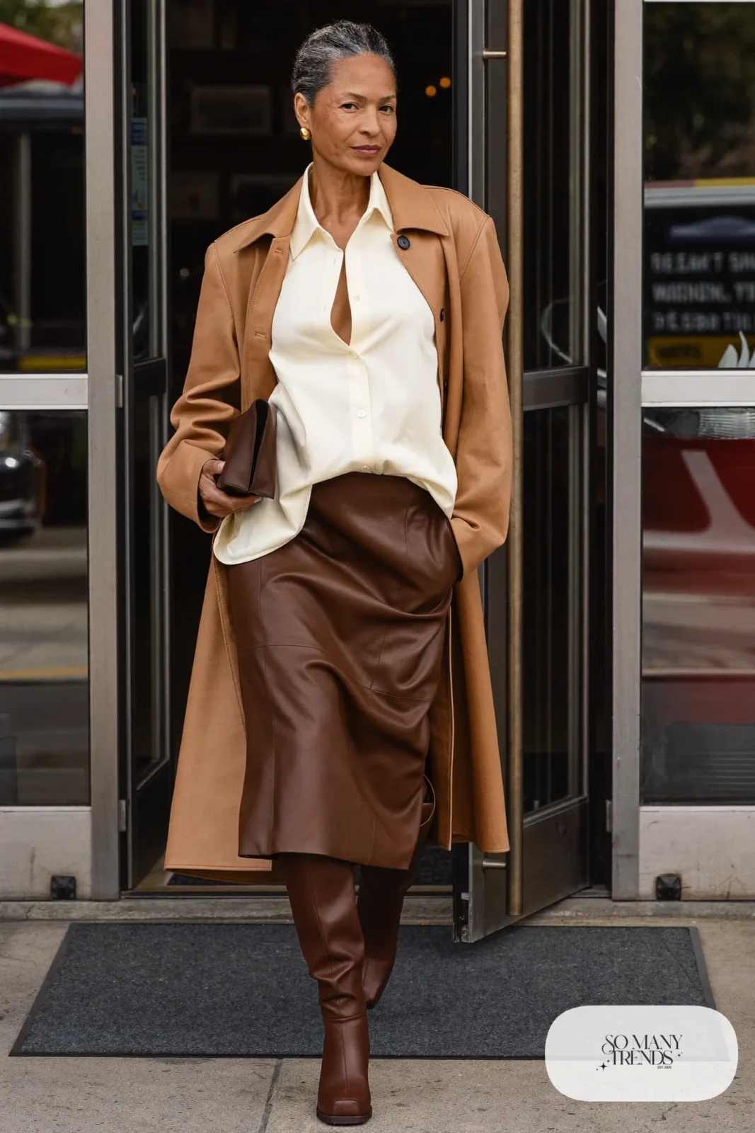 ivory silk blouse chocolate leather midi skirt camel long coat brown block-heel boots gold earrings office outfit 7