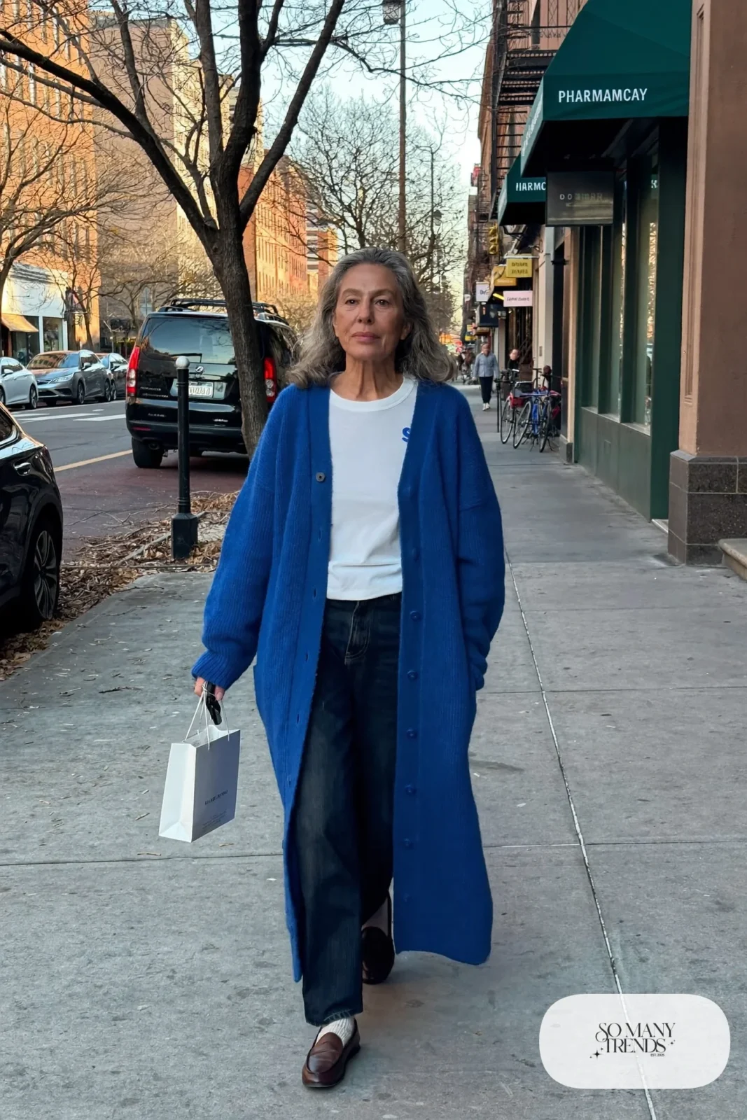 woman over 60 in cobalt blue long cardigan coat white tee dark straight jeans brown loafers socks outfit 3