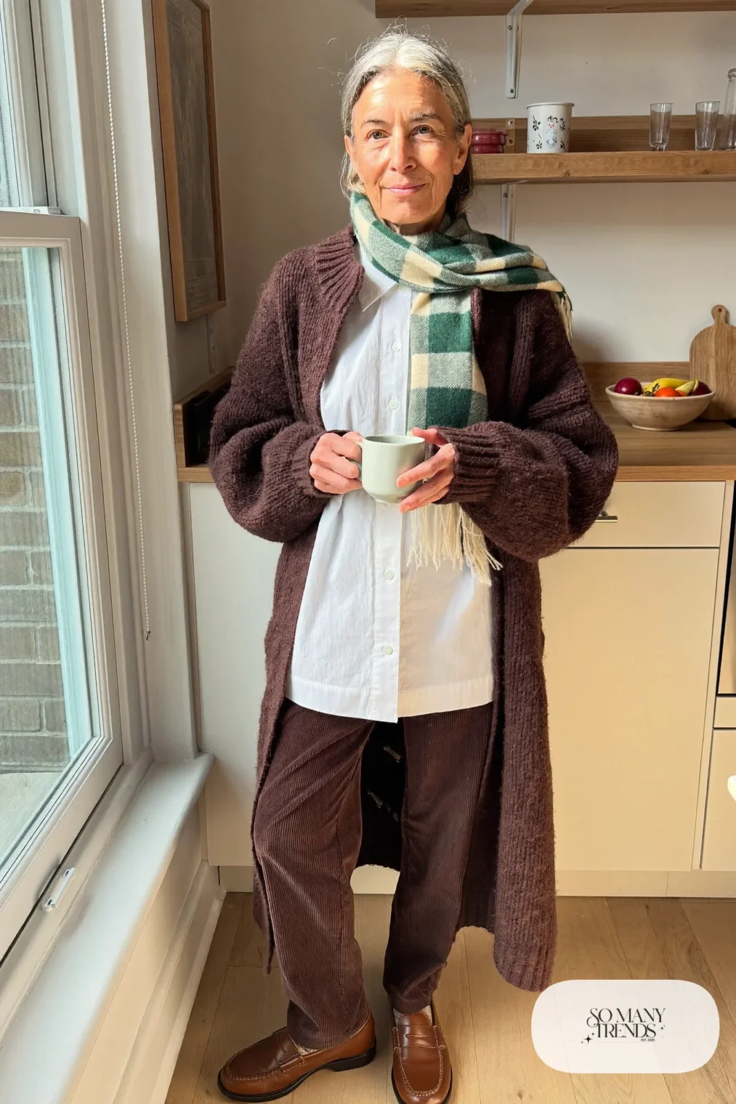 woman over 60 in oatmeal long cardigan white blouse brown corduroy pants green plaid scarf loafers outfit 7