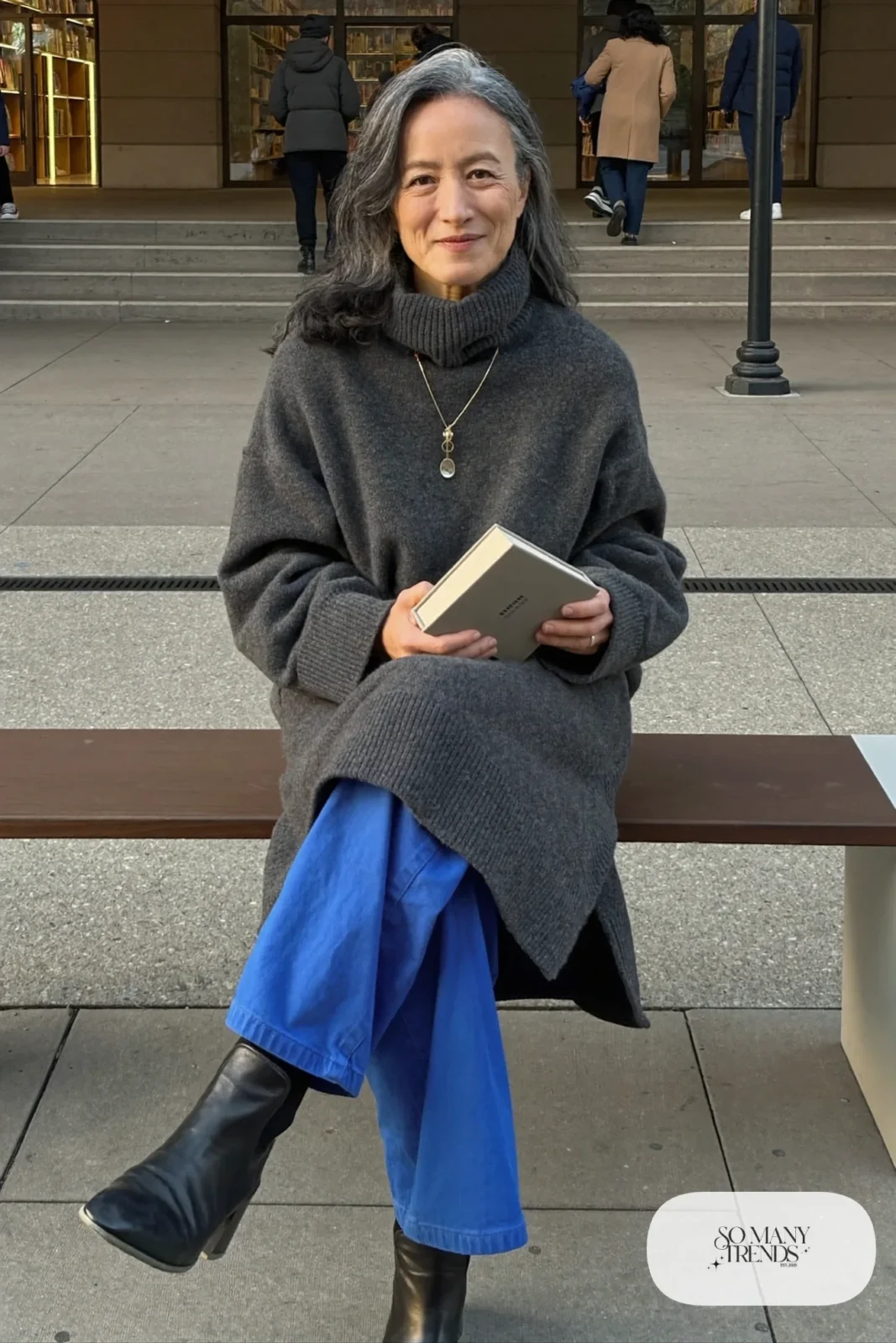 woman over 60 in charcoal gray turtleneck cobalt blue wide-leg pants black ankle boots silver necklace outfit 8