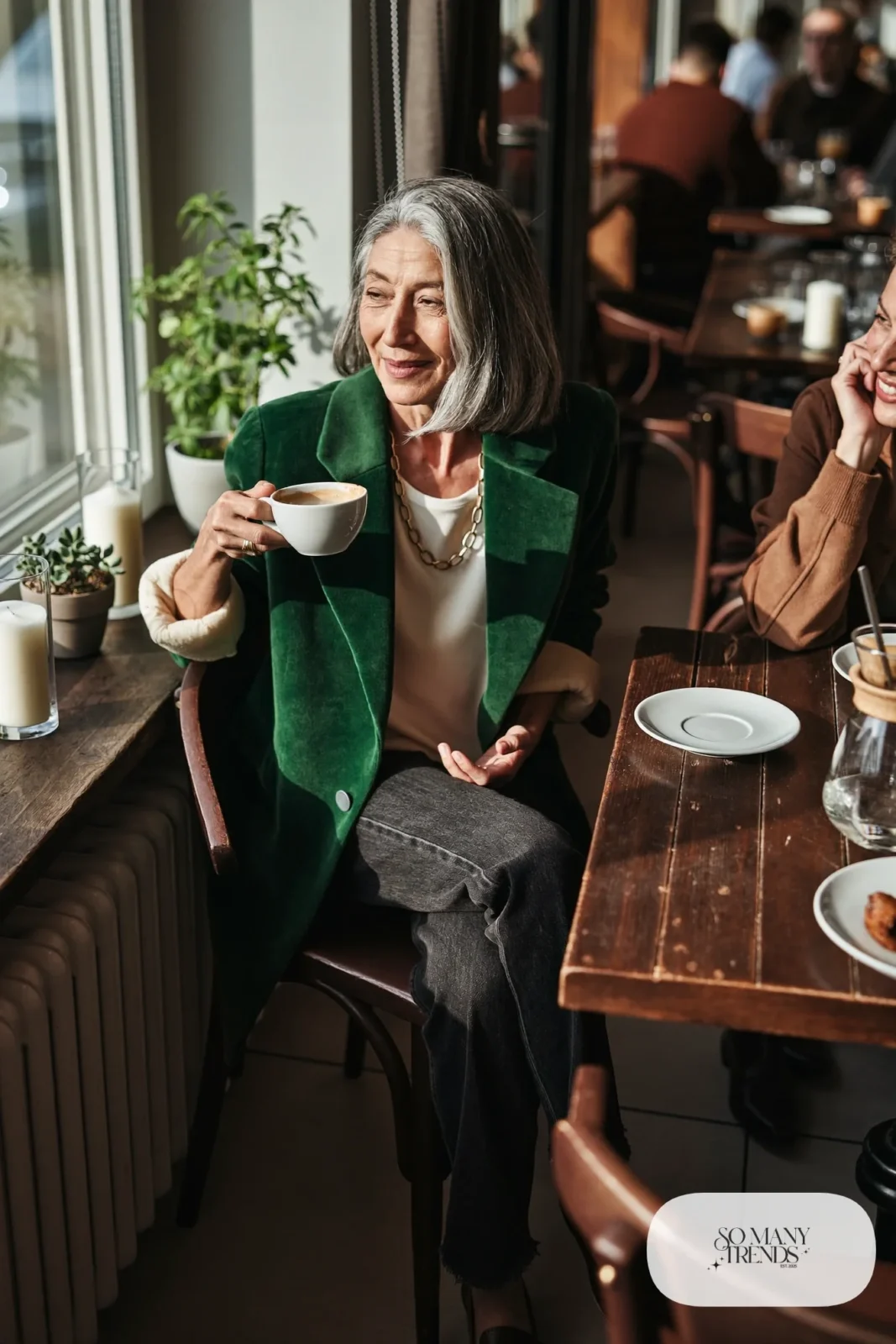 woman over 60 in forest green velvet blazer cream tee dark jeans gold chain necklace loafers outfit 14