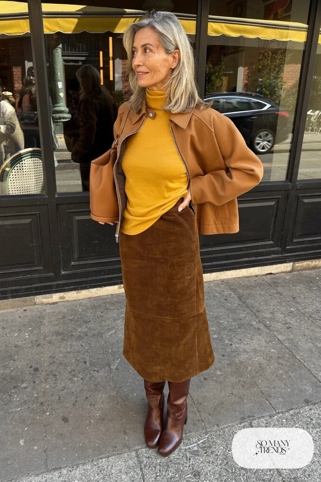 woman over 60 in mustard turtleneck long brown corduroy skirt tall boots camel jacket outfit 16