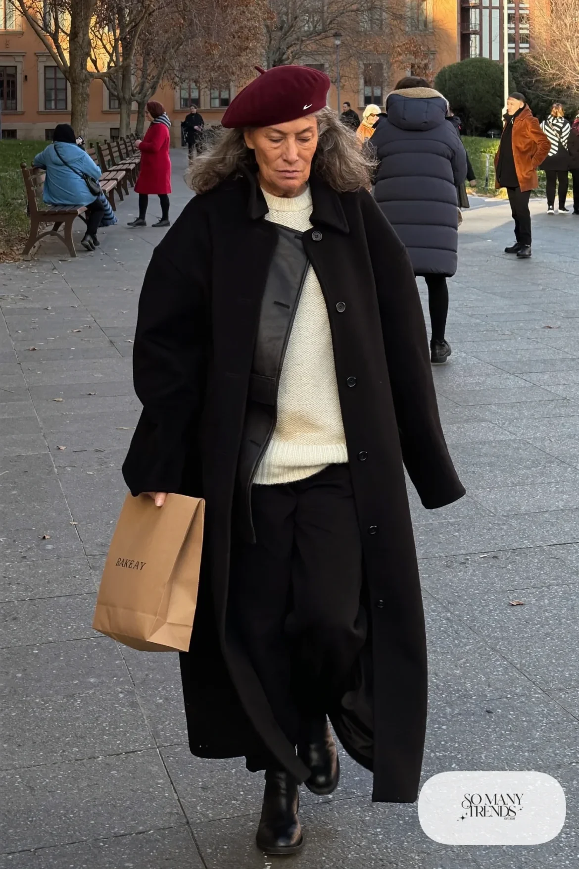 woman over 60 in black wool coat burgundy beret cream sweater black pants ankle boots outfit 17