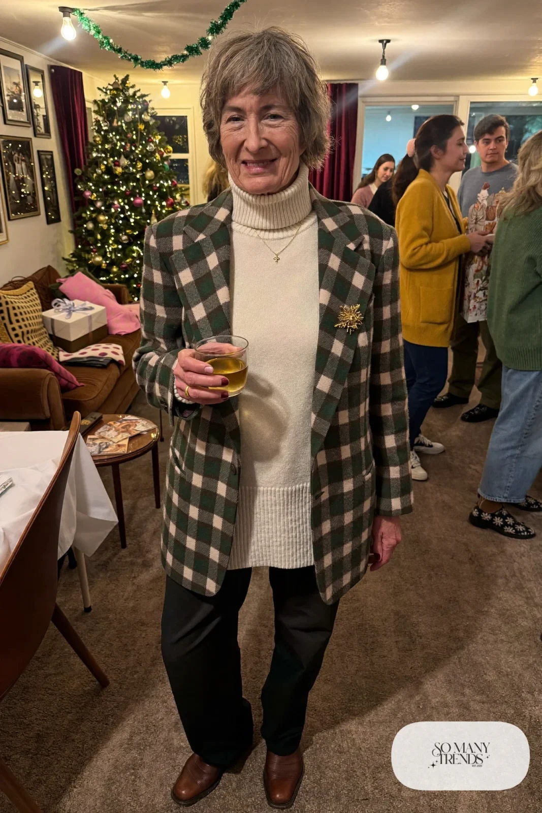 woman over 60 in brown cream plaid blazer cream turtleneck dark pants brown ankle boots brooch outfit 23