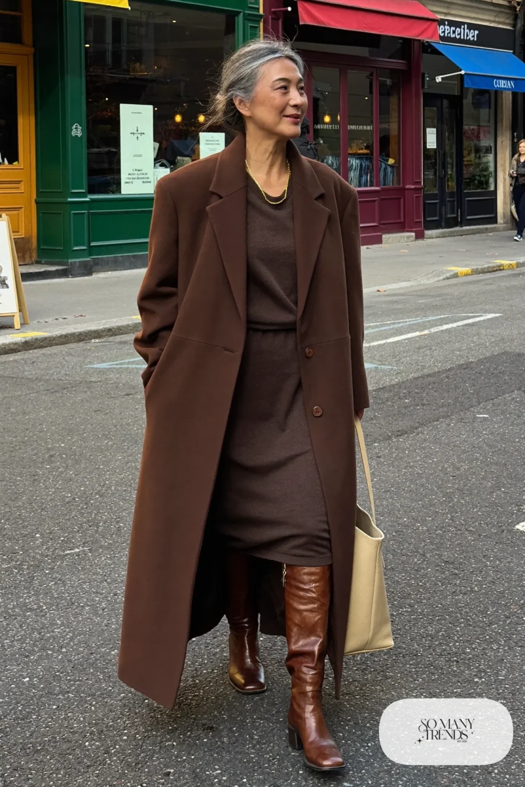 woman over 60 in chocolate brown knit midi dress tall boots camel coat gold chain outfit 27